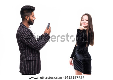 Man photographing a girl over white background