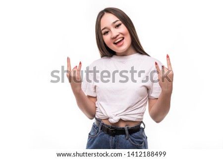 Young asian business woman wearing glasses over isolated background shouting with crazy expression doing rock symbol with hands up. Music star. Heavy concept.