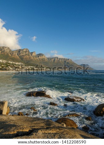 Beautiful coastal view of Camps Bay coastline and 12 Apostles with Atlantic Ocean waves breaking onto rocks and beach. Cape Town. Western Cape. South Africa.