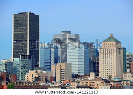 Montreal city skyline over river in the day with urban buildings