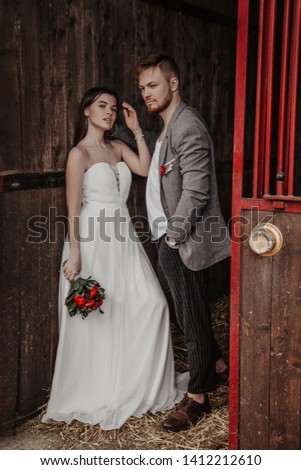Happy bride and groom on the stable