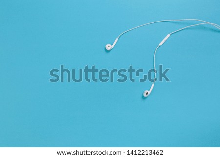 white headphones on blue background  -  Image