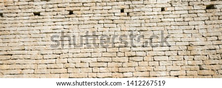 Limestone wall of an old buliding. Blocks of traditional building material  in Estonia. Cheap way of setting up farm houses and other buildings in rural areas 100 yars ago.