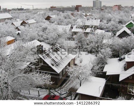 top view of an urban village or city with wooden houses in winter trees covered with snow, view of the surroundings