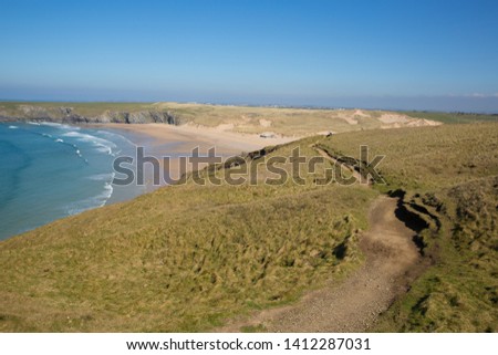 South west coast path Holywell bay North Cornwall with blue sea waves and sky Royalty-Free Stock Photo #1412287031