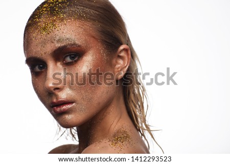 Portrait of a beautiful woman with expressive creative make-up in bronze. Studio beauty photo session. White background