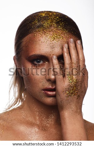 Portrait of a beautiful woman with expressive creative make-up in bronze. Studio beauty photo session. White background