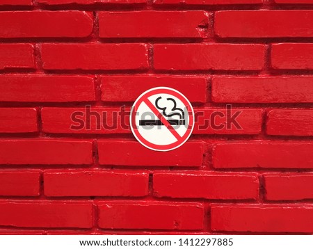 No smoking sign on the red brick wall