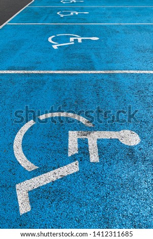 image of blue marking on asphalt disabled parking