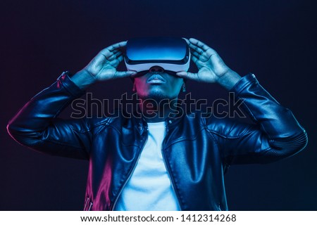 African american man in vr glasses, watching 360 degree video with virtual reality headset isolated on black background