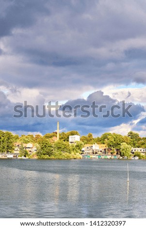 Old residential area at the Ziegelsee in Schwerin under dramatic clouds. Mecklenburg-Vorpommern, Germany