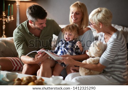 Parents with cute child and grandma together in the room
