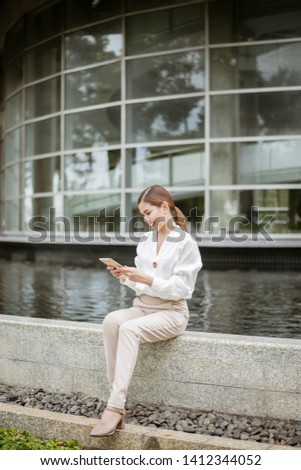 Beautiful business woman is working outside office 