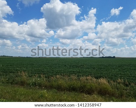 Clouds in the sky over a green field
