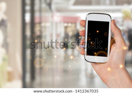 Man hand holding the black smartphone with blank screen and modern frame less design - isolated on white background
    
    - Image