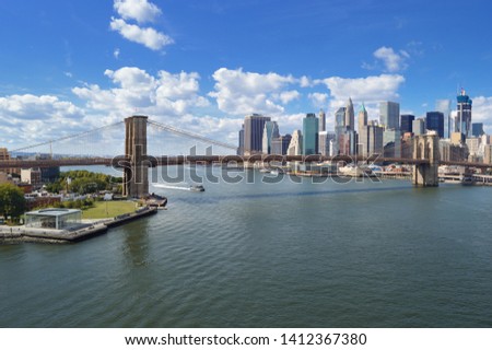 East River panorama with Brooklyn Bridge at sunny day.