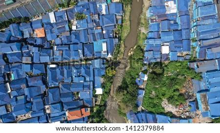 
aerial vierw housing with a blue roof in Malang city, Indonesia Royalty-Free Stock Photo #1412379884