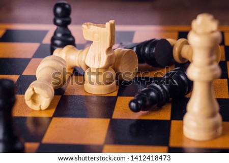 wooden black and white handmade chess on a wooden checkered board