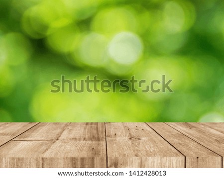 empty wood desk and green bokeh background