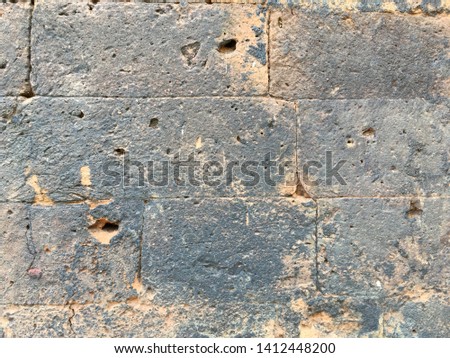 Old dark sand stone wall texture and background 