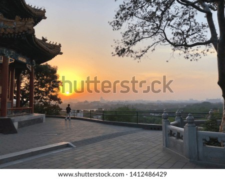 View of the sunset in Beijing by Jingshan Park, an imperial park immediately north of the Forbidden City in the Imperial City area of Beijing, China.