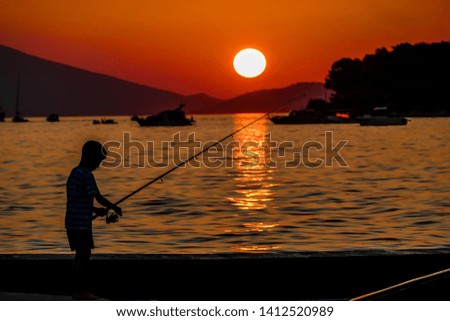 silhouette of a fisherman at sunset, beautiful photo digital picture