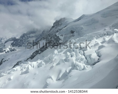 Snow on mountains with white cloud as background in Switzerland
