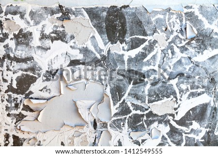 Background with the image of the old white wall with falling off and exfoliated paint and plaster on site of the ruins with a chaotic and chaotic texture requiring repair. Pattern with lime and crack