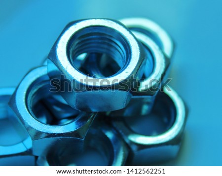 
nuts industrial abstraction close up blurred blue background