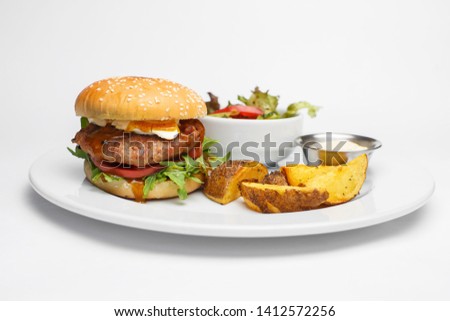 burger with potato and salad on a white background