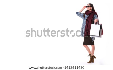 Fashion girl with shopping bag isolated on white background.