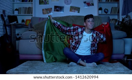 Teenager with Portuguese flag supporting national team home, sports competition