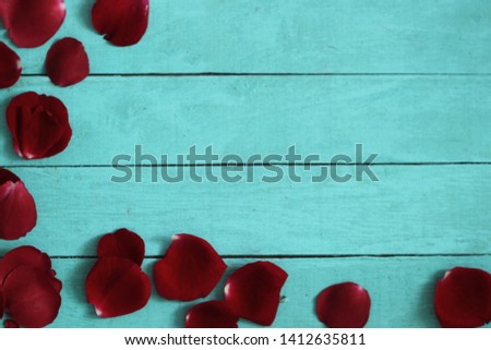 Roses petals on wooden background. Valentines day concept
