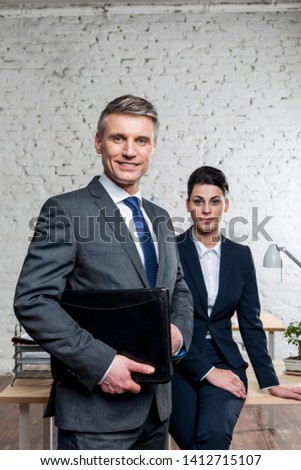 Portrait of confident business colleagues standing at office