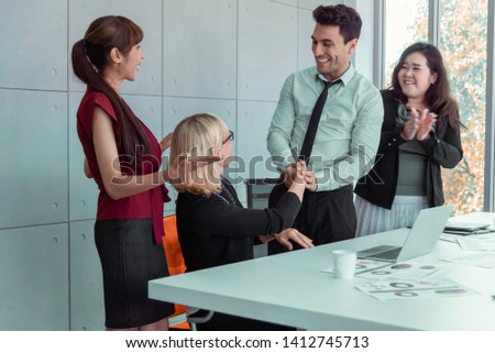 Congratulations. A group of people working as a team in the Office to congratulate. Business Office women on wheelchair. The Success Business Teamwork. Business People Teamwork Meeting Corporate. 
