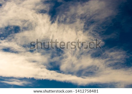 Fluffy white cumulus clouds with some cumulostratus and cirrus formations on a summer afternoon are contrasted against the  Australian sky creating a fascinating cloud scape.