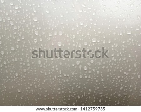 Drops on shiny metal floors for background or graphic design.Wet car surface in the rain