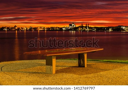 Lonely seat as the sunset explodes in the sky 