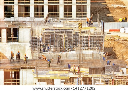 construction site overview of workers working on to build up concrete residential building city development industry team work background aerial side view of people in safety uniform at work place