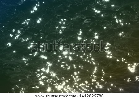 nice yellow painted highlights on dark water surface texture - abstract photo background