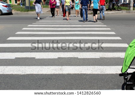 pedestrian crossing over a road with people