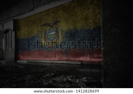 painted flag of ecuador on the dirty old wall in an abandoned ruined house. concept