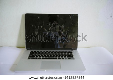 Broken laptop screen on a light background close up