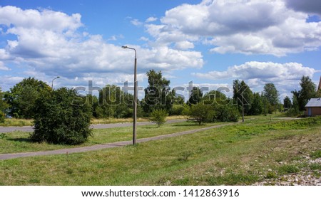 green meadow under blue sky in countryside in summer
