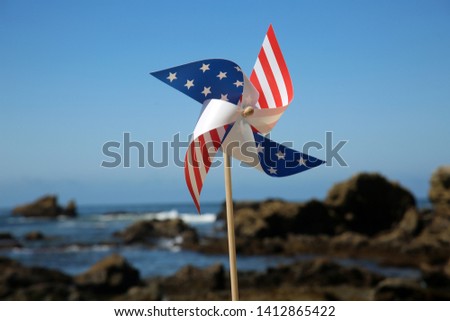 American Flag pin wheel at the beach. American Flag Pinwheel
in the sand on a beach.
