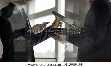 Lawyer opening case and looking at money, concept of illegal job offer, bribe Royalty-Free Stock Photo #1412909198