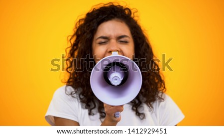 African-American woman using megaphone for protest, public opinion, politics Royalty-Free Stock Photo #1412929451