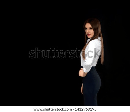 girl in office clothes on a dark background. Long-haired burning office employee. Dark key