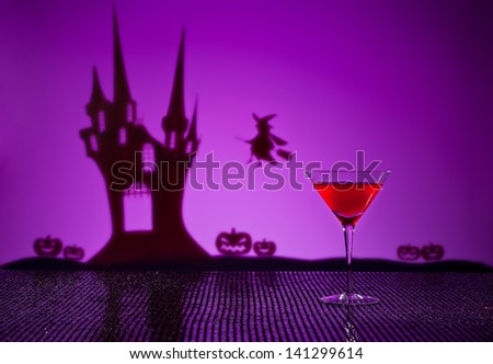 Halloween haunted house witch and a Cosmopolitan cocktail