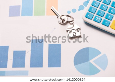 Property finance business concept image for financial market. House key on graphic charts